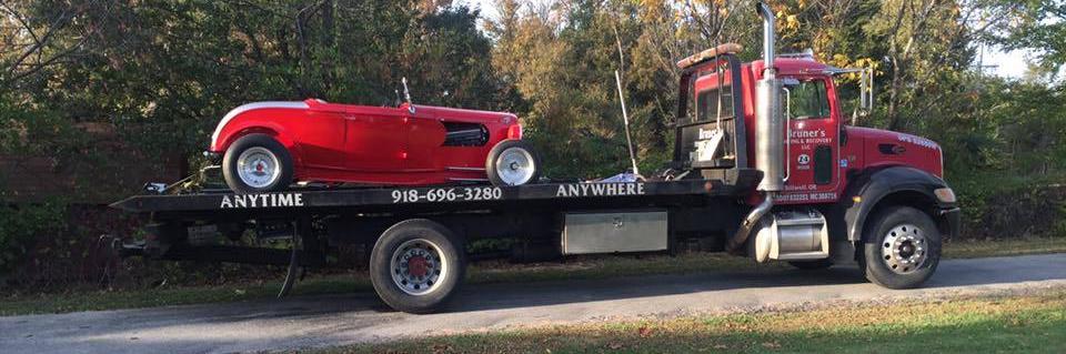 truck towing an antique car